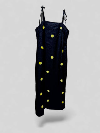 Front full-length view of DREAM Sister Jane Fanciful Flower black jacquard midi dress featuring yellow 3D beaded daisy flower appliqués.