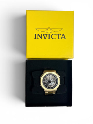 Activa x Invicta Signal Dual Time gold-tone unisex watch model ACWM423-007 with an octagonal brushed metal case and black digital-analog dial layout.